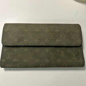 Used green fabric international LV wallet.